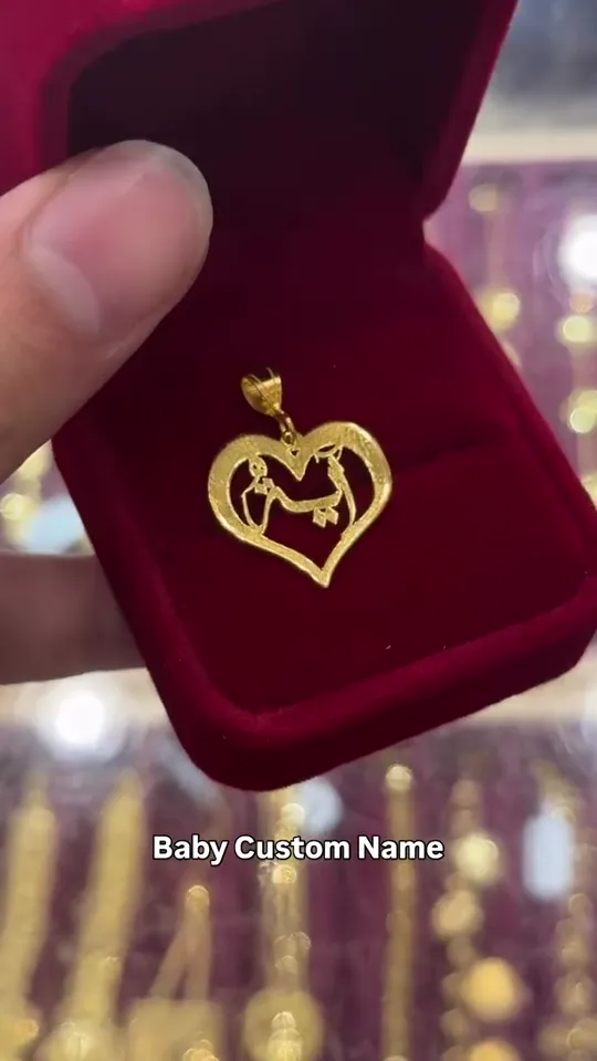 A name pendant cut for a baby, in its box
